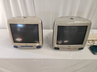 two old televisions sitting on a table next to each other