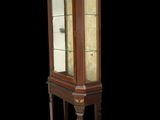 a display cabinet with a glass door on the top of it