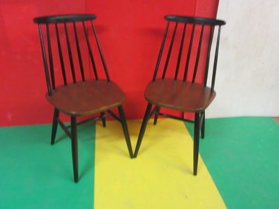 deux chaises en bois placées l'une à côté de l'autre sur un sol coloré