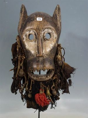 an image of a mask on a stand with a tag on it