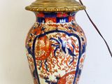 a lamp that is sitting on a stand with a light on it