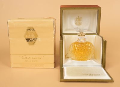 an image of a bottle of perfume in a box on a table