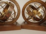 two wooden booksends with a globe on top of them