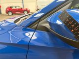 a blue car with a sticker on the side of it