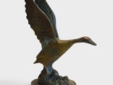an image of a bronze statue of a duck on a pedestal