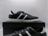 men ' s adidas sneakers in black and white with a white stripe on the side