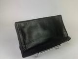 black leather clutch bag with metal frame on white background