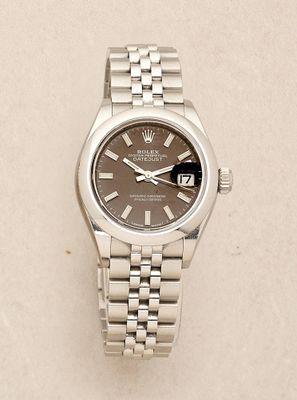 an image of a wrist watch with a brown dial on a white surface