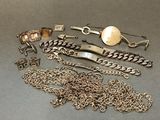 plusieurs types différents de bijoux en argent posés sur un fond gris