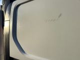 a close up of a white truck with the door open