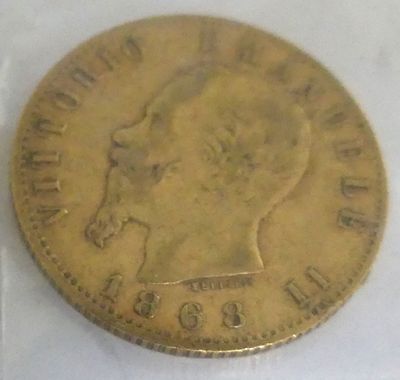 a close up of a gold coin with a woman ' s head on it
