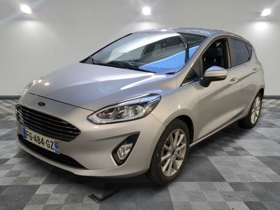 a silver ford fiesta parked on a checkered tile floor