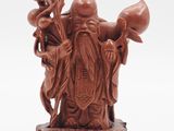 chinese carved figurine of a man holding a pot and a bird