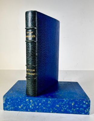 an old blue book sitting on top of a blue book stand