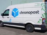 a white van that is parked in front of a building