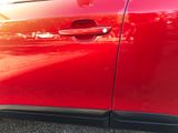 a close up of a red car door handle