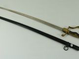 an old sword with a black handle and a gold handle