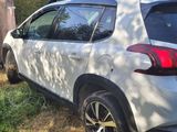 a white car that is parked in the grass