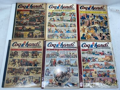 several comics are on display on a table in front of a white background