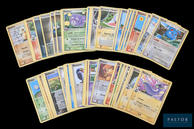 a lot of pokemon cards that are on the table