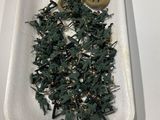 a white tray with a bunch of miniature army men on it