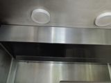 a stainless steel oven with two exhaust fans above it