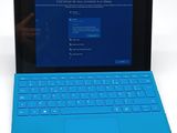 the surface of a laptop computer with a blue keyboard on it
