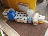 many containers of water and containers of liquid on the floor