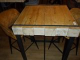 a wooden table with four chairs around it