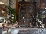 a lot of antiques on display in a store