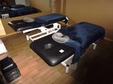 deux tables de massage dans une pièce où il y a un miroir accroché au mur