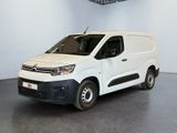 the white van is parked in a large room with a ceiling fan