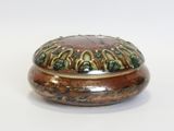 a brown and green box on a white surface