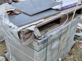 a pile of junk on the ground next to a building