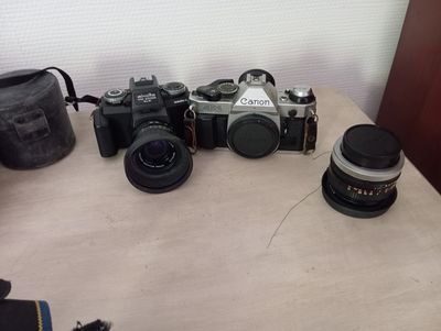 many cameras sitting on a table next to each other