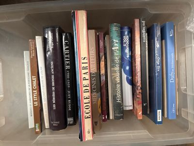 many books in a plastic box on the shelf