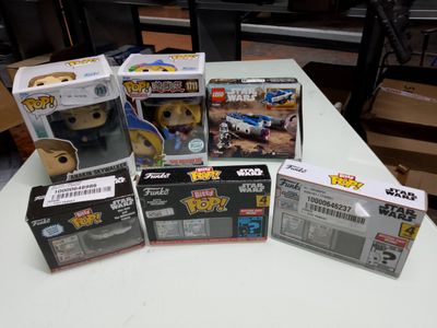 a lot of star wars pop vinyl figures on the table