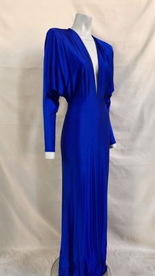 a blue dress on a mannequin stand against a white backdrop