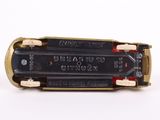 a close up of a small toy train on a white surface