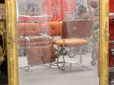 a mirror that is sitting on a table next to a chair
