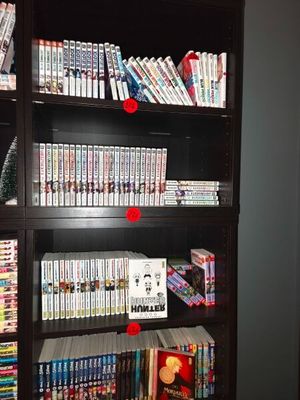 a book shelf with many dvds on it in a room