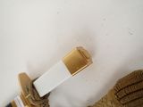 a white and gold belt with a gold buckle on it