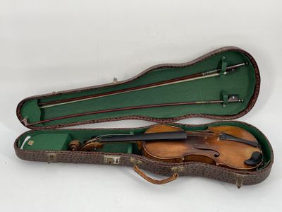 an old violin case with a violin in it on a white surface