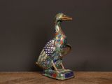 an image of a bird figurine sitting on top of a wooden table