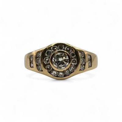 a close up of a gold and diamond ring on a white background