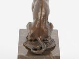 bronze statue of a dog sitting on a marble base