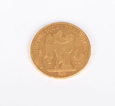 a gold coin on a white surface with a white background