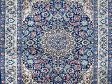 a blue rug with a medallion design on it