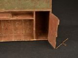 a small wooden box with a door open on a black surface