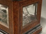 a glass case with a clock inside of it